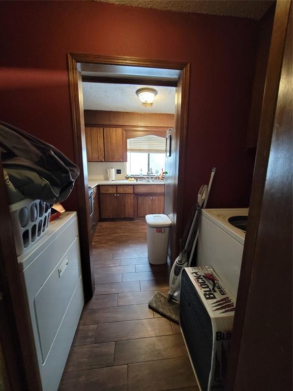 laundry area with dark hardwood / wood-style flooring and washer / clothes dryer