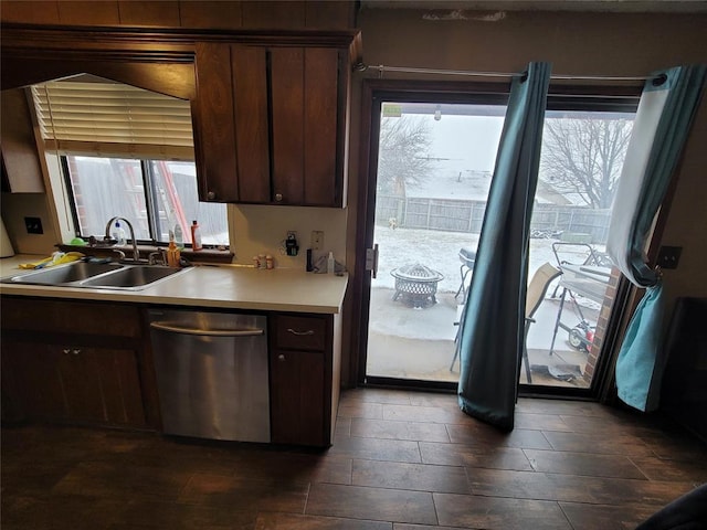 kitchen featuring sink, dark brown cabinets, and dishwasher