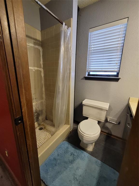 bathroom with vanity, curtained shower, and toilet