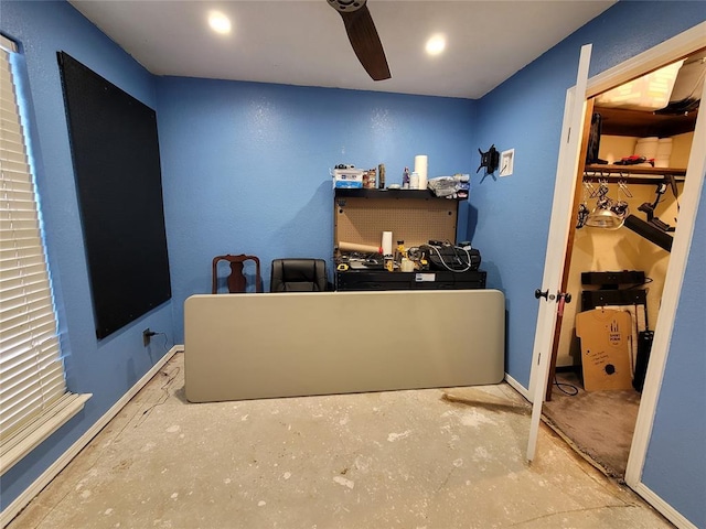 office space featuring ceiling fan and concrete flooring