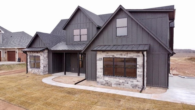 modern farmhouse featuring a large fireplace and a front yard