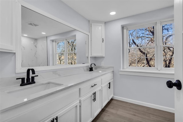 bathroom with hardwood / wood-style floors and vanity