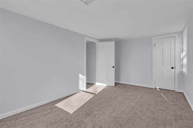 unfurnished room featuring carpet