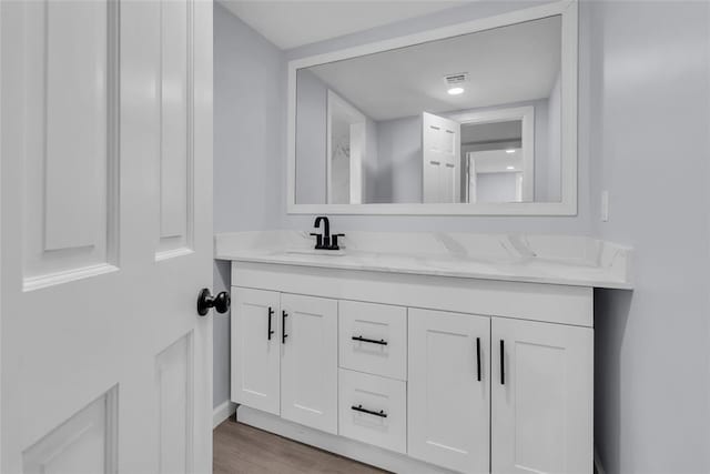 bathroom featuring vanity and hardwood / wood-style flooring