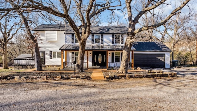 front of property with a porch and a garage