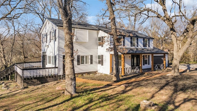 exterior space featuring a porch and a front yard