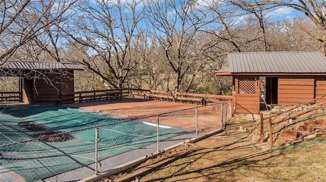 exterior space with an outbuilding and a covered pool