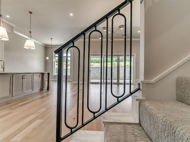 2408 Lazio Way, Edmond, OK 73034 - stairway featuring crown molding, wood finished floors, and recessed lighting