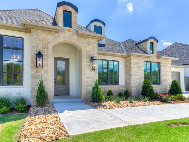 2408 Lazio Way, Edmond, OK 73034 - property entrance featuring stone siding and roof with shingles