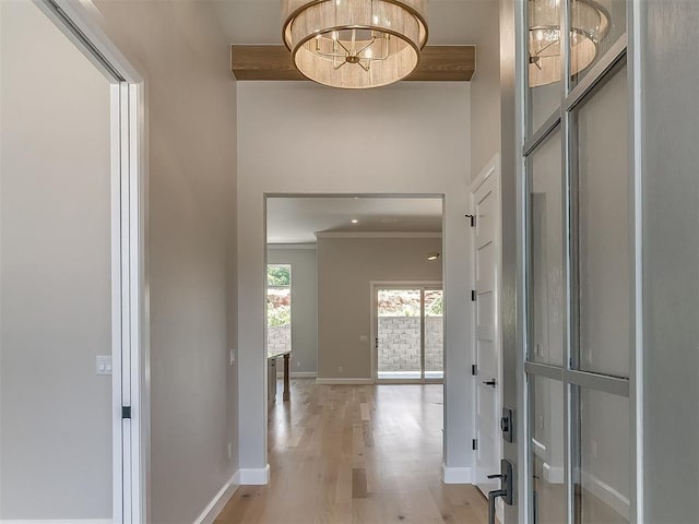 2408 Lazio Way, Edmond, OK 73034 - foyer featuring light wood-style floors, a chandelier, and crown molding