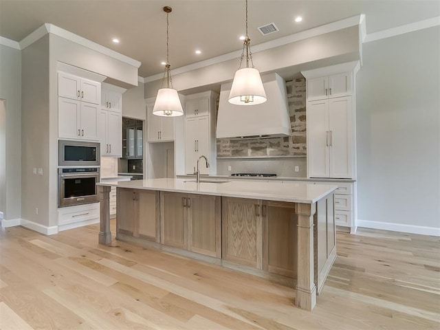 2408 Lazio Way, Edmond, OK 73034 - kitchen featuring appliances with stainless steel finishes, crown molding, light countertops, tasteful backsplash, and custom range hood