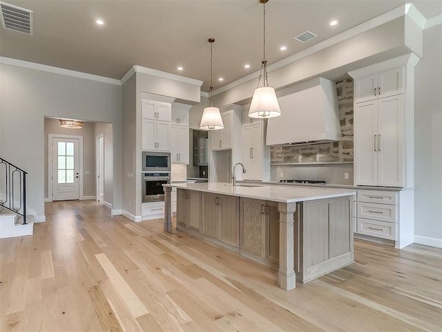 2408 Lazio Way, Edmond, OK 73034 - kitchen featuring stainless steel appliances, custom exhaust hood, decorative backsplash, crown molding, and light countertops
