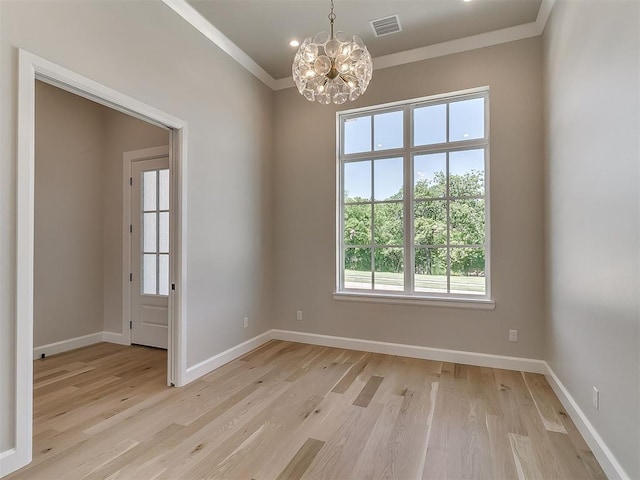 2408 Lazio Way, Edmond, OK 73034 - unfurnished room featuring a chandelier, light wood finished floors, and crown molding