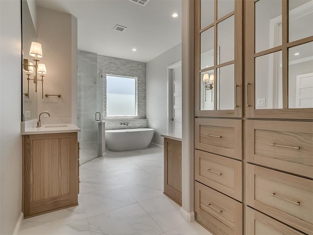 2408 Lazio Way, Edmond, OK 73034 - full bathroom featuring vanity, a shower stall, a freestanding tub, marble finish flooring, and recessed lighting