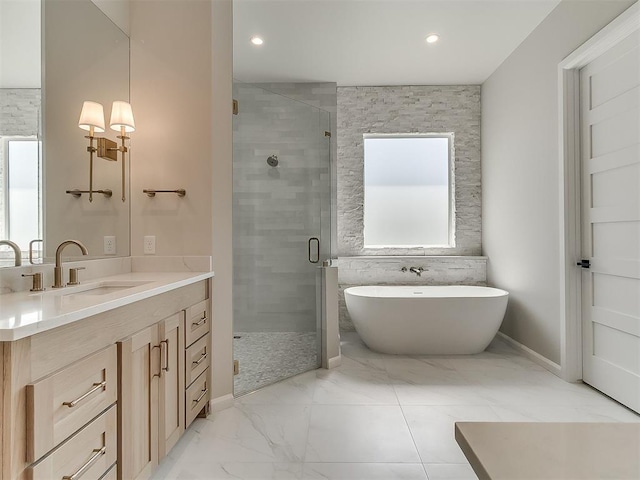 2408 Lazio Way, Edmond, OK 73034 - bathroom with vanity, a stall shower, a freestanding bath, marble finish flooring, and recessed lighting