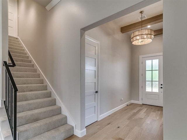 2408 Lazio Way, Edmond, OK 73034 - entrance foyer featuring beamed ceiling, stairway, light wood-style floors, and a chandelier