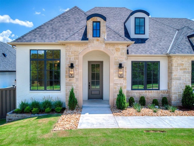 2408 Lazio Way, Edmond, OK 73034 - view of front facade with stone siding, roof with shingles, and a front yard