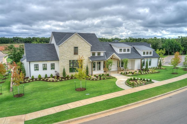 2408 Lazio Way, Edmond, OK 73034 - modern inspired farmhouse featuring stone siding, a shingled roof, and a front yard