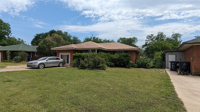 view of front of house with concrete driveway and a front yard