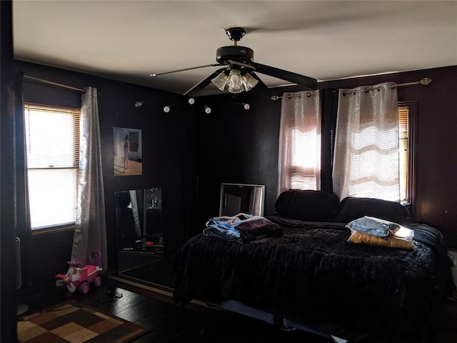 bedroom with ceiling fan and wood finished floors