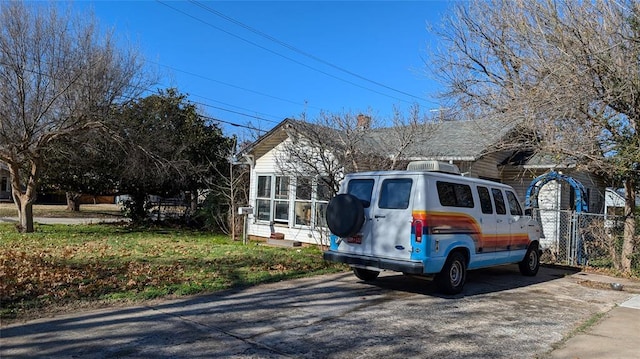 view of front of property with a sunroom and fence