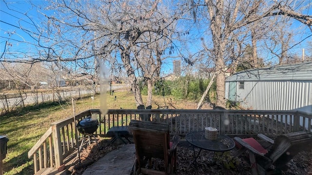 wooden deck with a lawn