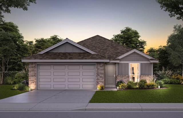 view of front of house with driveway, a garage, a yard, board and batten siding, and brick siding