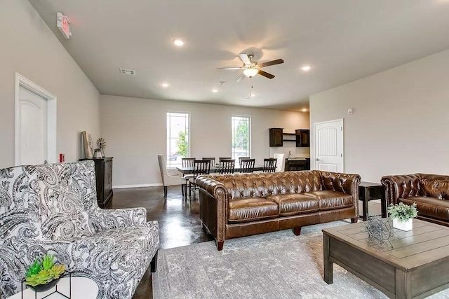 living room with finished concrete floors, recessed lighting, visible vents, and a ceiling fan