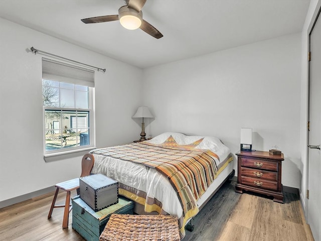 bedroom with light hardwood / wood-style flooring and ceiling fan