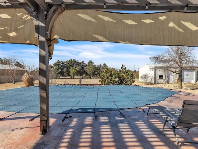 view of swimming pool with a patio