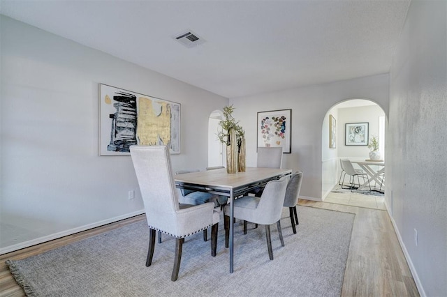 dining space with light hardwood / wood-style flooring