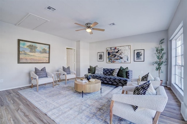 living room featuring ceiling fan, a healthy amount of sunlight, and hardwood / wood-style flooring