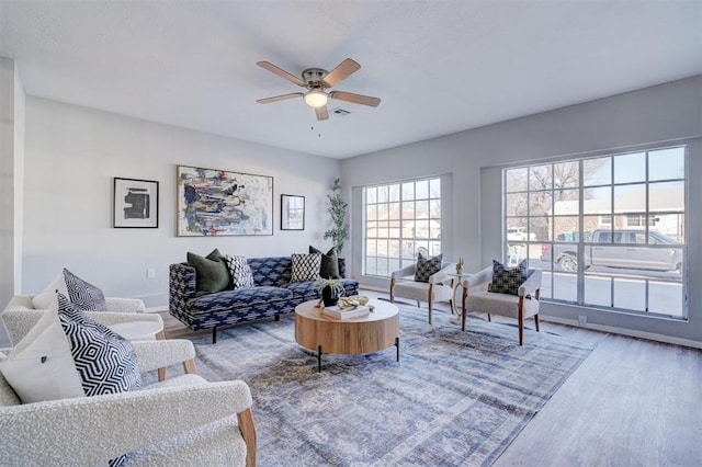 living room featuring ceiling fan and wood-type flooring