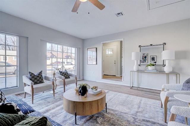 living room featuring ceiling fan and light hardwood / wood-style flooring