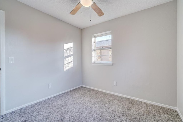 carpeted spare room featuring a textured ceiling and ceiling fan