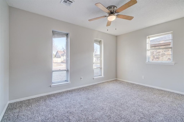 unfurnished room featuring carpet flooring, ceiling fan, and a textured ceiling