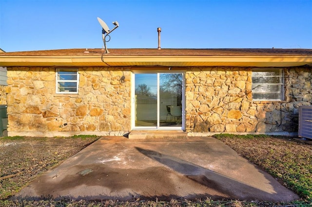 rear view of house featuring central AC and a patio