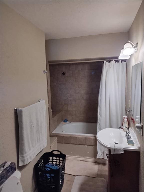 full bathroom featuring tile patterned flooring, vanity, toilet, and shower / tub combo