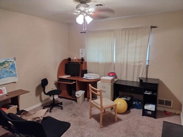 carpeted office space featuring ceiling fan