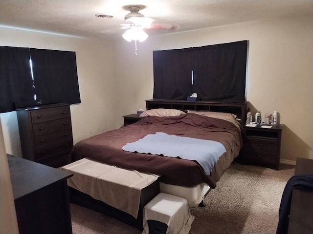 bedroom with light carpet and ceiling fan