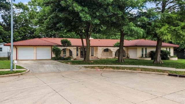 view of front of property with a front lawn and a garage