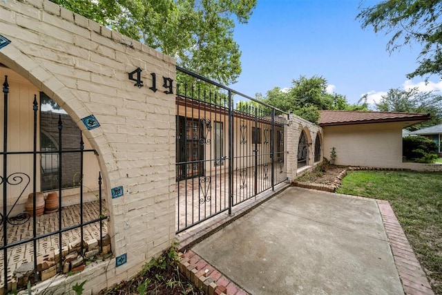 view of gate with a patio area