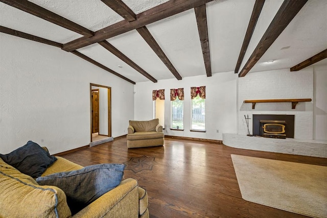 unfurnished living room with vaulted ceiling with beams, a brick fireplace, and hardwood / wood-style flooring