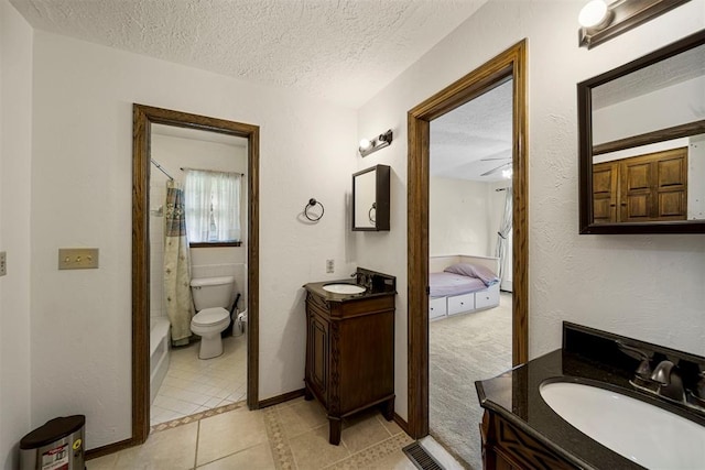 bathroom with walk in shower, vanity, a textured ceiling, tile patterned flooring, and toilet