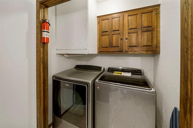 laundry room with cabinets and washing machine and dryer