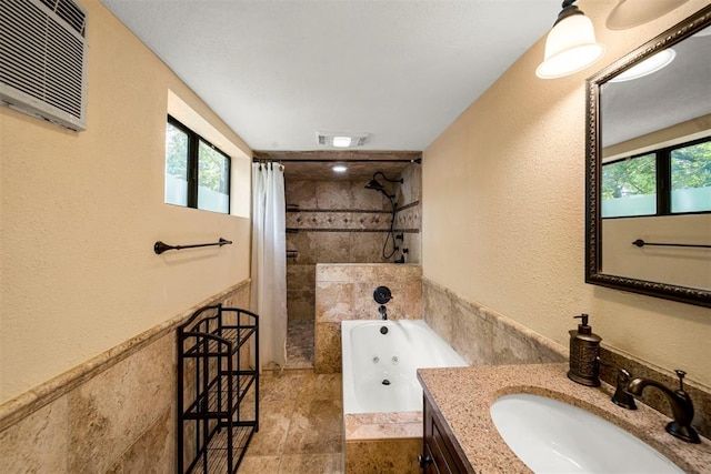 bathroom with vanity, shower with separate bathtub, and a wall mounted AC