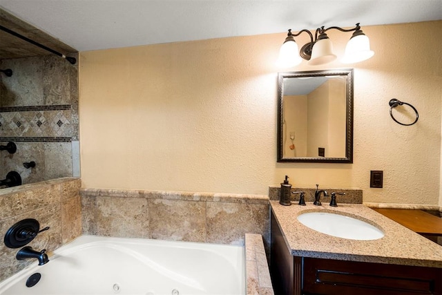 bathroom with vanity and tiled tub