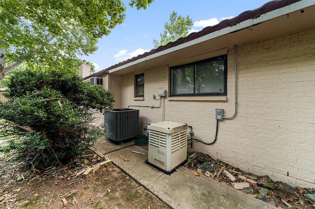 view of side of home with central AC