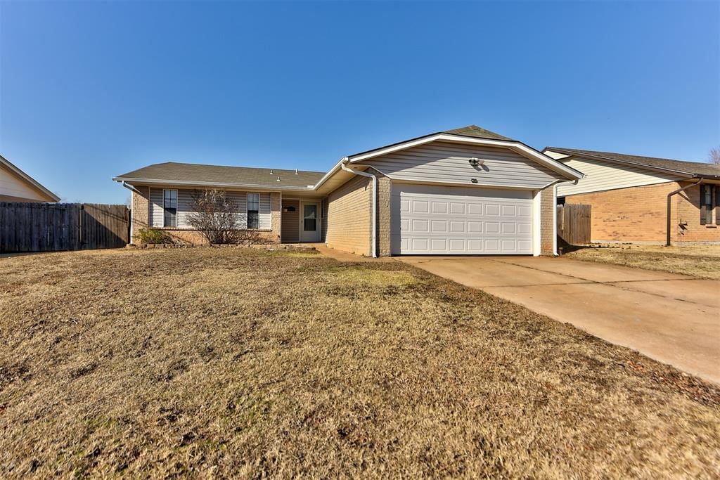 single story home with a garage and a front yard