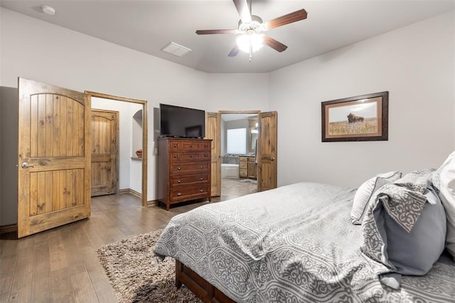 bedroom with hardwood / wood-style flooring, ceiling fan, and ensuite bathroom